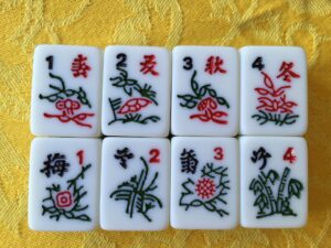 Bonus tiles for playing Mahjong. Top row: spring, summer, autumn, winter. Bottom row: plum blossom, orchid, chrysanthemum, bamboo.